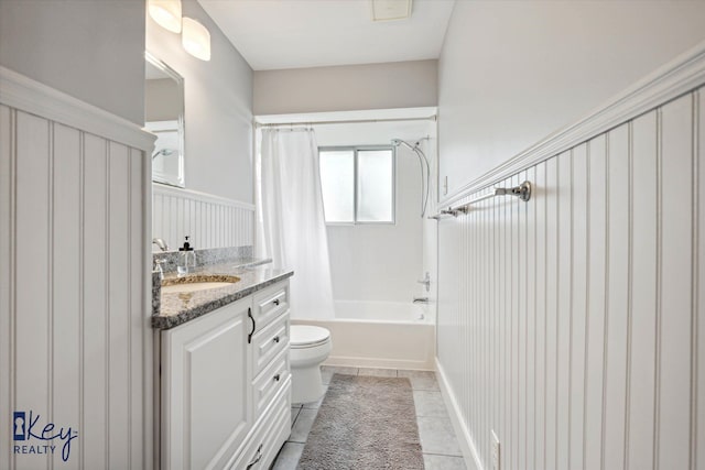 full bathroom with tile patterned floors, vanity, toilet, and shower / bath combo with shower curtain