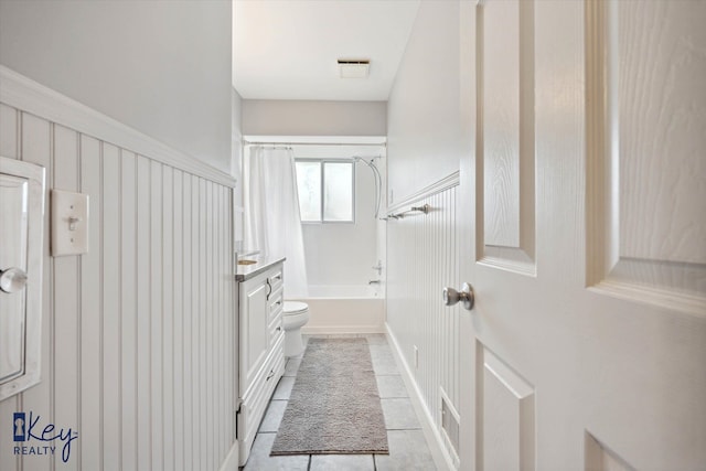 full bathroom with tile patterned flooring, shower / bath combination with curtain, toilet, and vanity