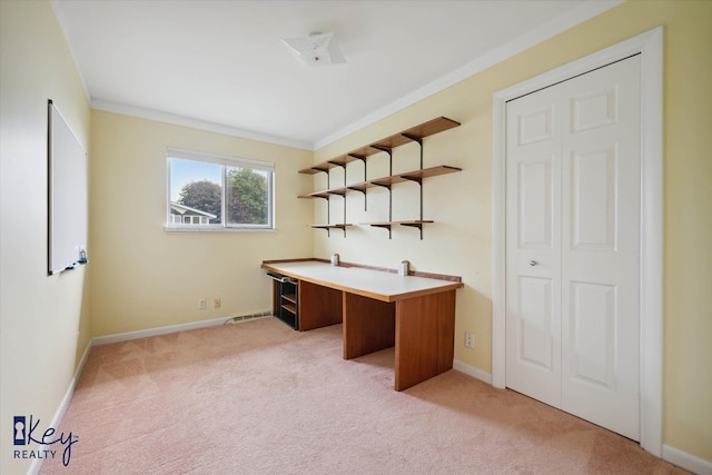 unfurnished office featuring light colored carpet and ornamental molding