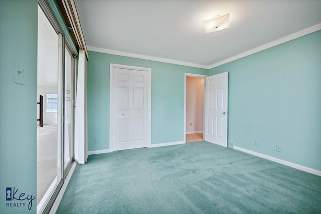 unfurnished bedroom featuring carpet flooring, a closet, and crown molding