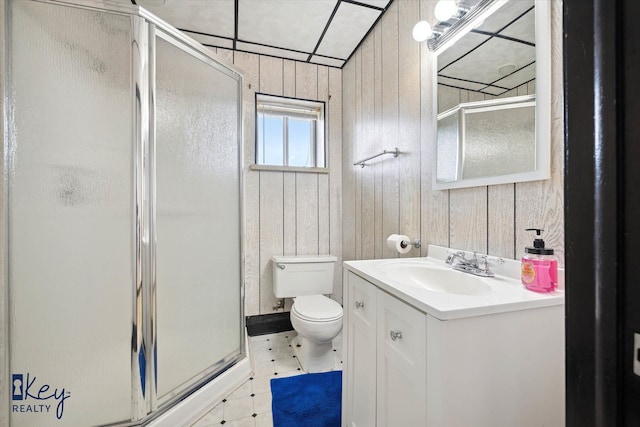 bathroom with wooden walls, vanity, an enclosed shower, and toilet