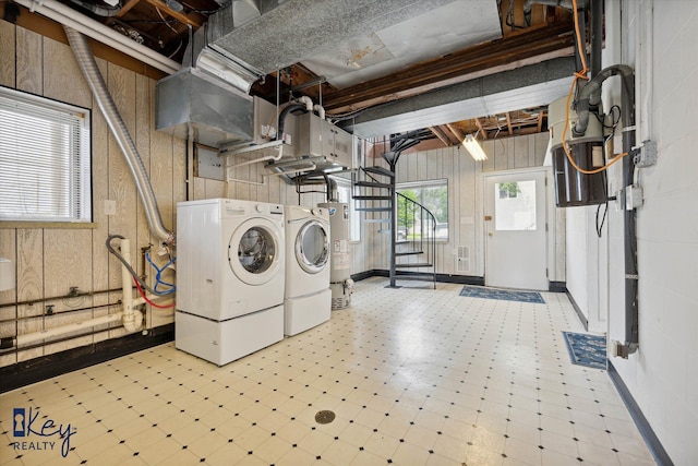 6800 Lakeshore Dr, Newport, MI 48166 - laundry room featuring gas water heater, separate washer and dryer, tile patterned floors, and wood walls