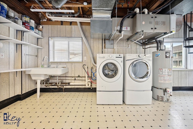 6800 Lakeshore Dr, Newport, MI 48166 - laundry room featuring water heater, tile patterned floors, washing machine and dryer, and wood walls