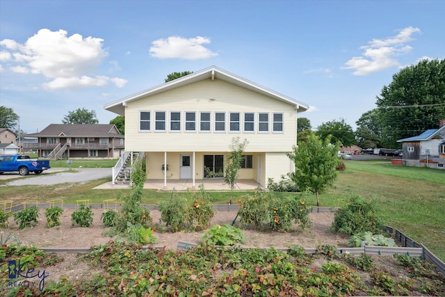 rear view of property featuring a patio area and a yard