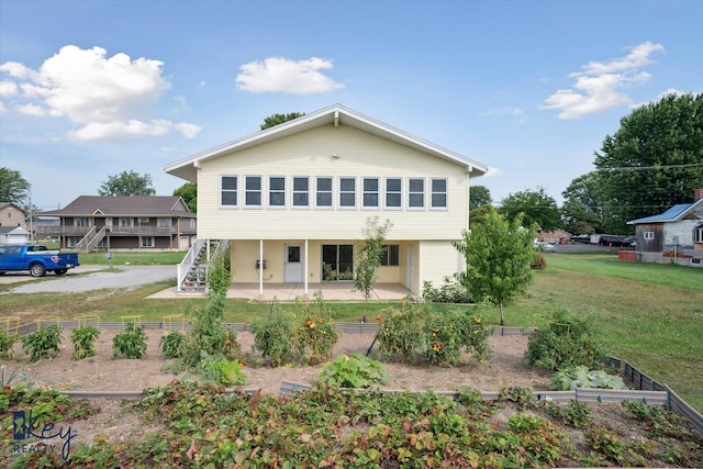 6800 Lakeshore Dr, Newport, MI 48166 - view of front of house featuring a patio area, a front yard, a vegetable garden, and stairs