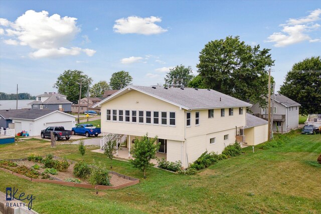 6800 Lakeshore Dr, Newport, MI 48166 - rear view of property with a garden, a lawn, a garage, and a residential view