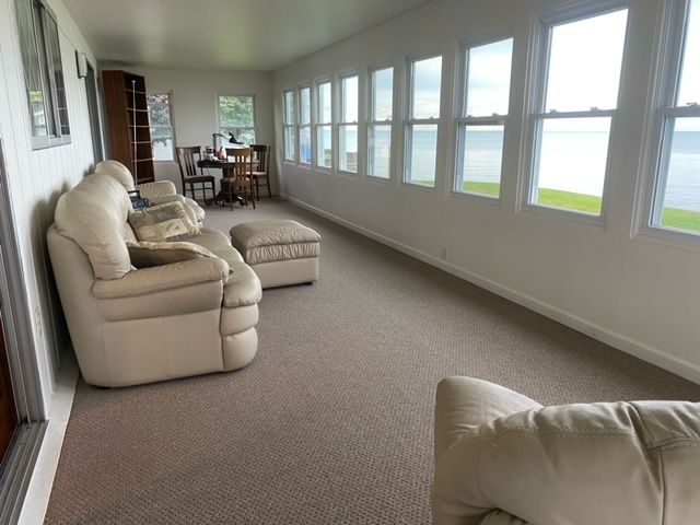 sunroom / solarium featuring a water view