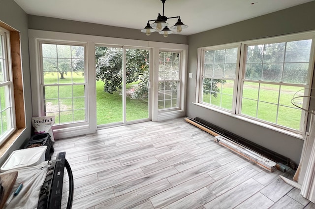 unfurnished sunroom featuring a chandelier