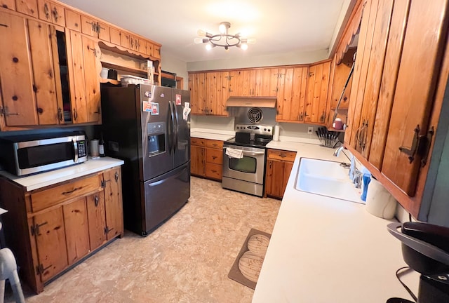 kitchen featuring appliances with stainless steel finishes, a notable chandelier, and sink