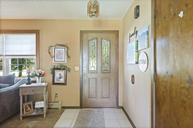 tiled foyer with a textured ceiling