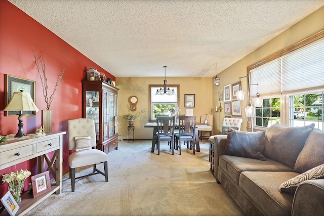 carpeted living room with a chandelier, a textured ceiling, and plenty of natural light