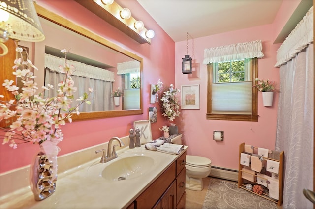 bathroom with tile patterned flooring, vanity, toilet, and baseboard heating