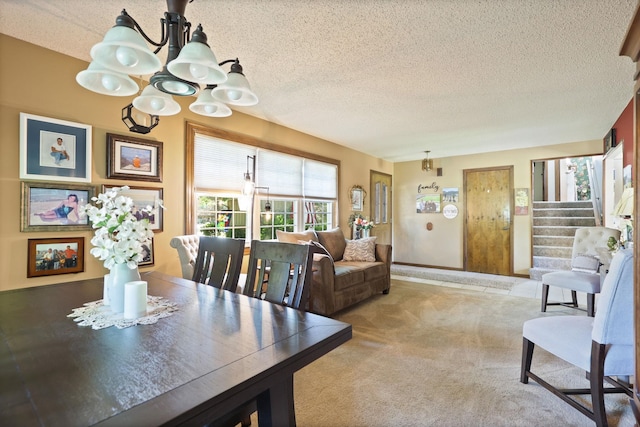 dining area with carpet flooring, a textured ceiling, and a notable chandelier