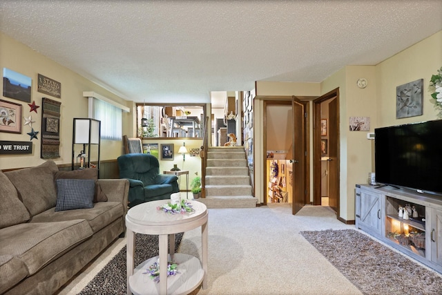 carpeted living room featuring a textured ceiling