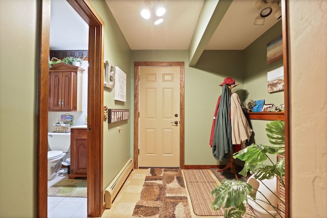 interior space with baseboard heating and light tile patterned flooring