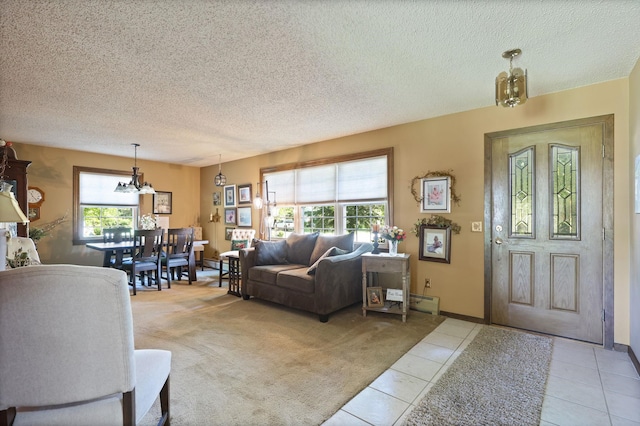 living room featuring a notable chandelier, light colored carpet, and a textured ceiling