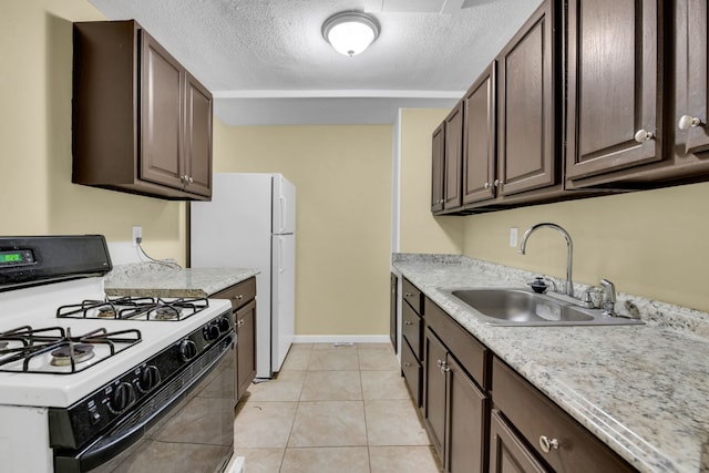 kitchen featuring sink, a textured ceiling, white appliances, dark brown cabinets, and light tile patterned floors