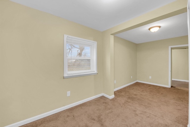 unfurnished room with light colored carpet