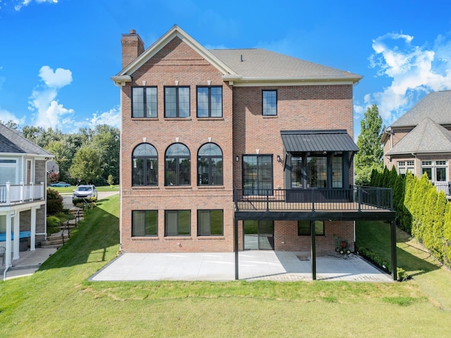 back of property featuring a wooden deck, a yard, and a patio