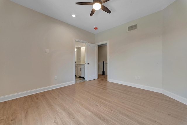 unfurnished bedroom with ensuite bathroom, light hardwood / wood-style flooring, and ceiling fan