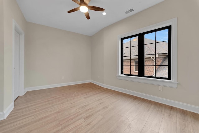 empty room with ceiling fan and light wood-type flooring