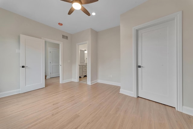 unfurnished bedroom with ensuite bath, ceiling fan, and light hardwood / wood-style floors