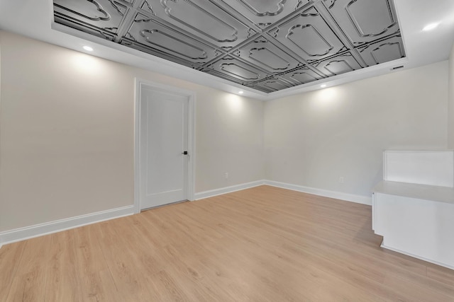 basement with light hardwood / wood-style floors