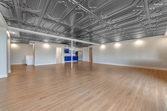 basement with light hardwood / wood-style flooring