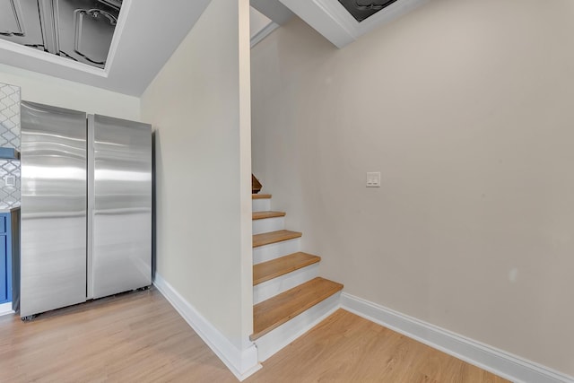 stairs featuring hardwood / wood-style floors