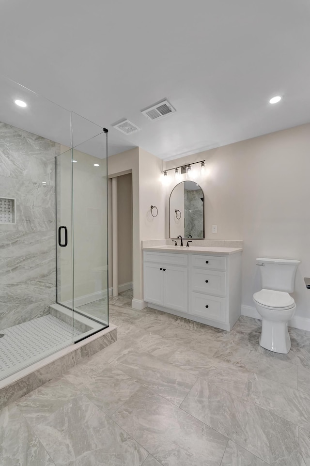 bathroom featuring toilet, vanity, and walk in shower