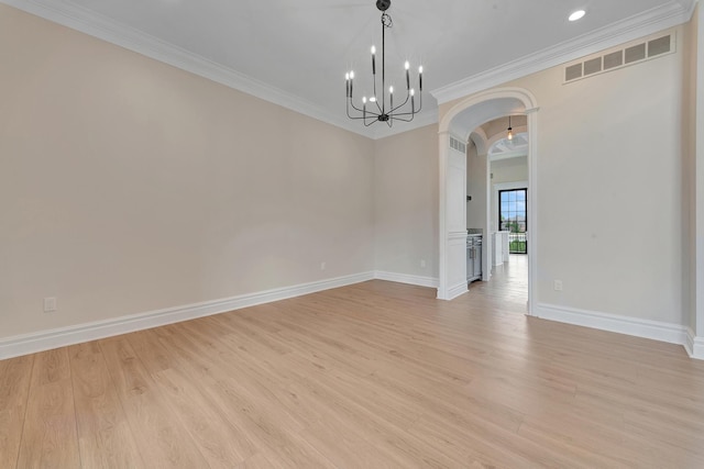 unfurnished room with a notable chandelier, light hardwood / wood-style floors, and crown molding