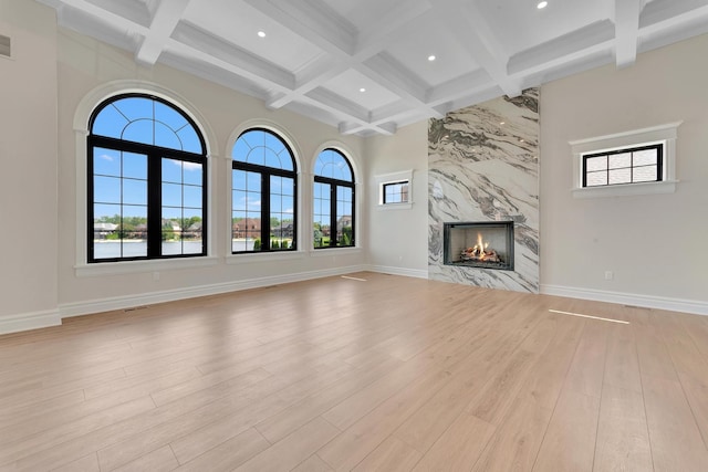 unfurnished living room with light wood-type flooring and a wealth of natural light