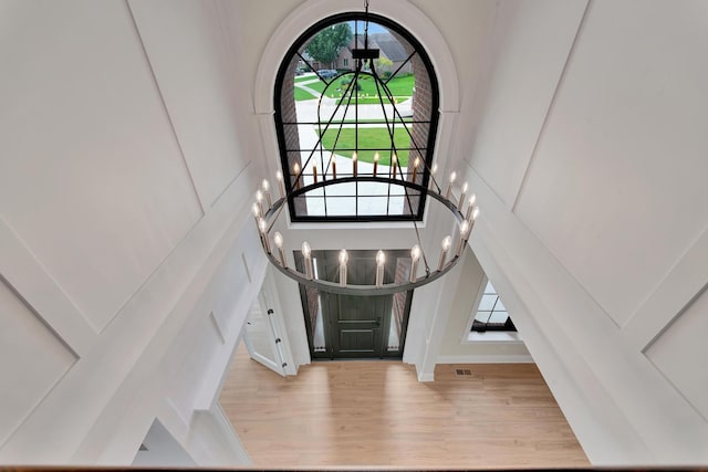 foyer entrance featuring a chandelier and light hardwood / wood-style floors