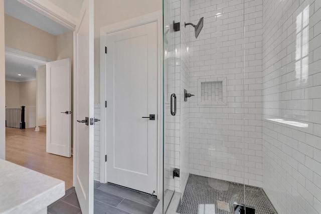 bathroom with hardwood / wood-style floors and a shower with door