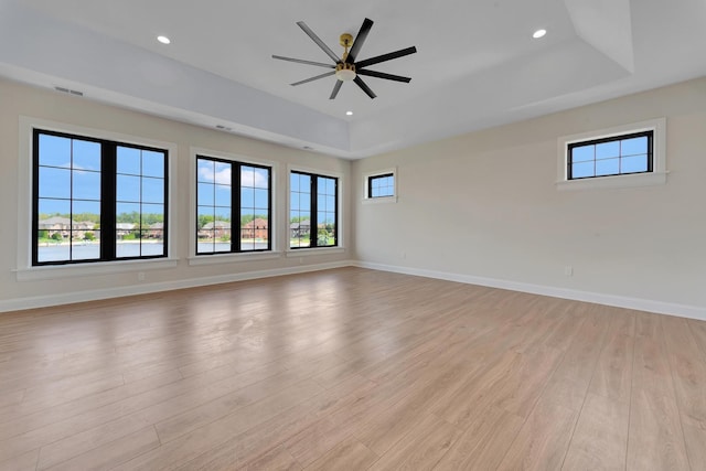 empty room featuring plenty of natural light and light hardwood / wood-style flooring