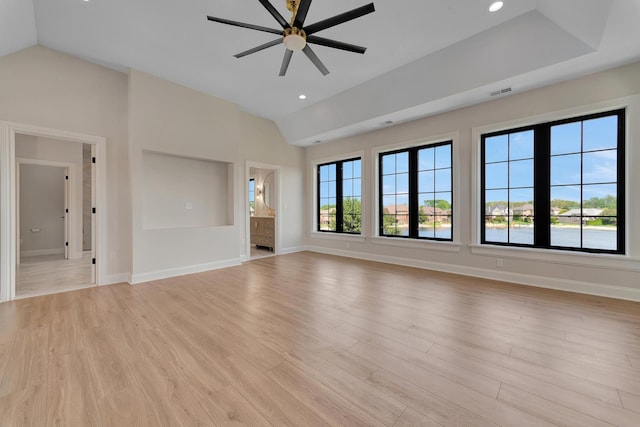 unfurnished living room featuring ceiling fan, light hardwood / wood-style floors, and vaulted ceiling