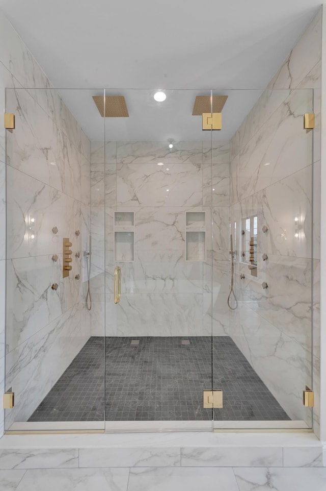 bathroom featuring a shower with shower door