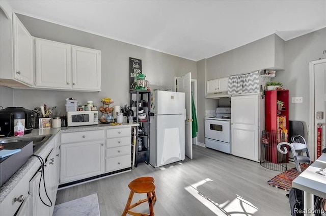 kitchen featuring white cabinets, white appliances, and light hardwood / wood-style flooring