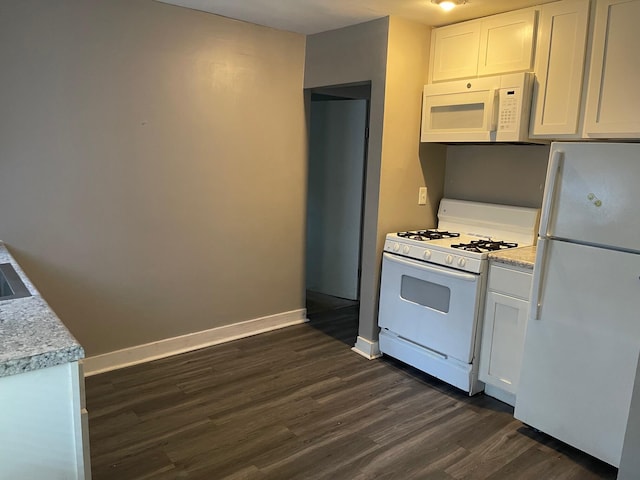 1981 Ray St, Muskegon, MI 49442 - kitchen with white appliances, dark wood-style floors, light countertops, and white cabinets