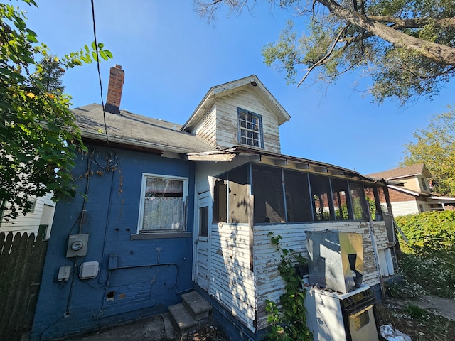 view of home's exterior with a sunroom