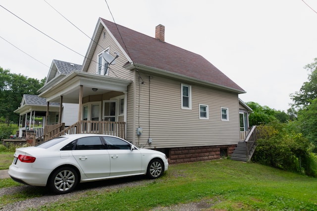 view of property exterior with a lawn and a porch