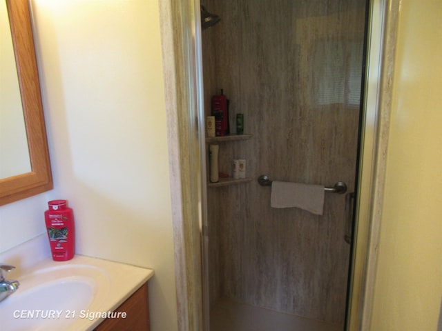 bathroom featuring vanity and a shower