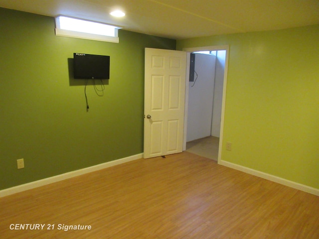 basement with light hardwood / wood-style flooring