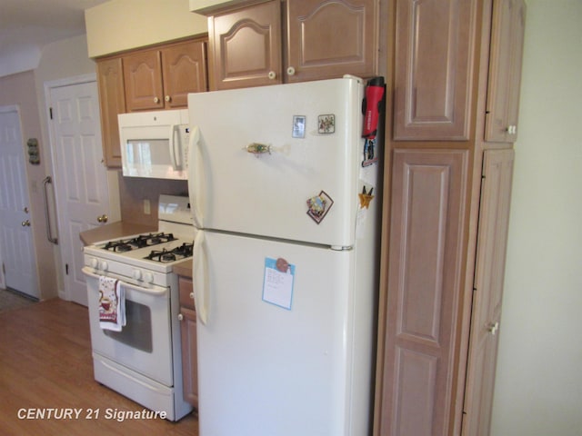 kitchen featuring light hardwood / wood-style flooring and white appliances