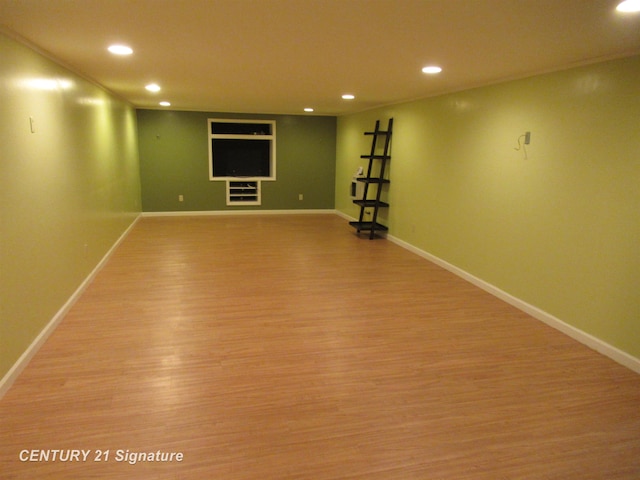 basement featuring crown molding and light wood-type flooring