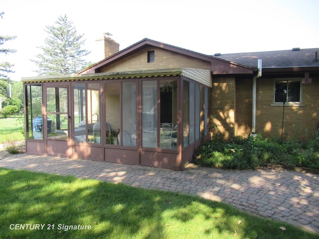 back of house with a sunroom