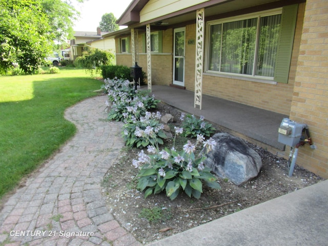 doorway to property featuring a lawn