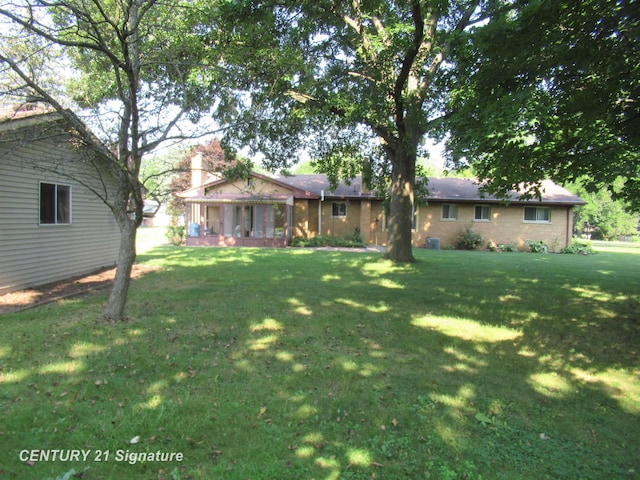 view of yard featuring a sunroom