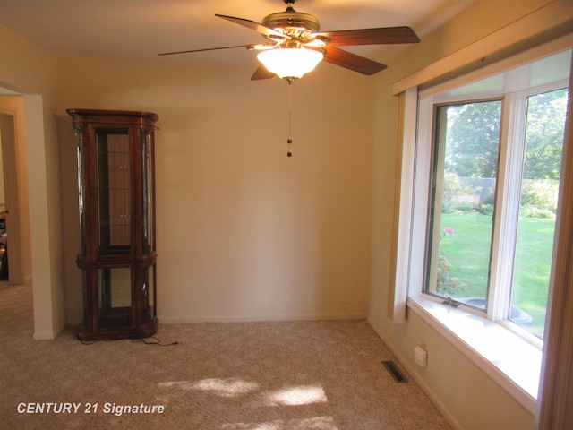 unfurnished room with ceiling fan and light carpet