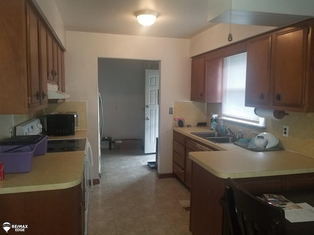 5439 Richfield Rd, Flint, MI 48506 - kitchen featuring under cabinet range hood, black microwave, light countertops, and range with electric stovetop